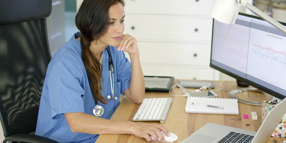 doctor reading data on her screen