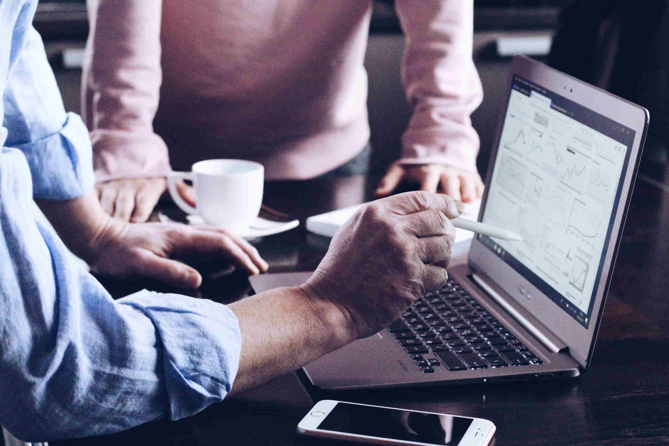 man showing data on his computer